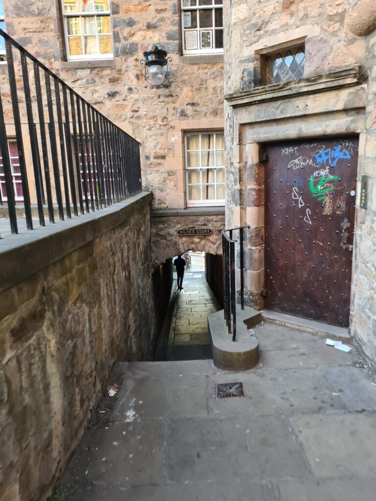 Photo taken down an Edinburgh wynd: a paved path between old stone buildings